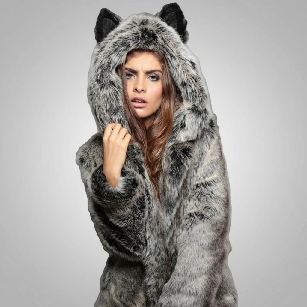 Woman wearing a gray fur coat with cat ears on a gray background